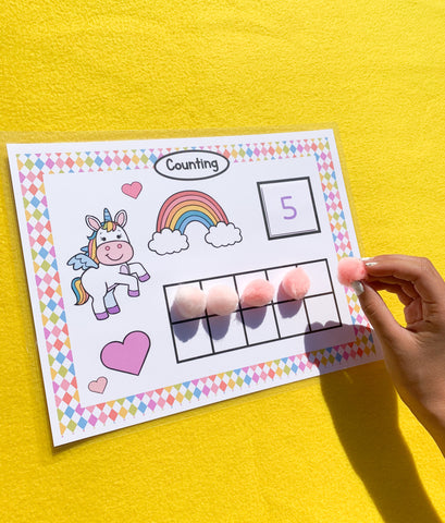 12 unicorn preschool learning activities in busy book printables. Your child will work on: colors, emotions, shapes, letters, dice game, patterns, puzzles, categorizing, counting, numbers, size, and play with the play dough mat. www.confetticrate.com