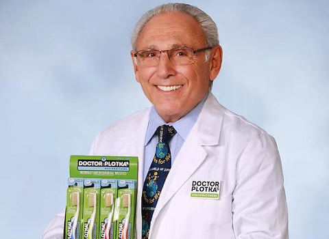 image of Dr. Ronald Plotka holding toothbrush box