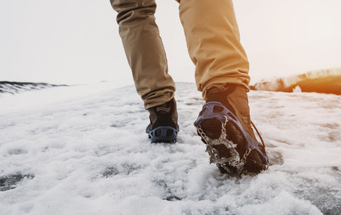 hiking in the snow with traction devices