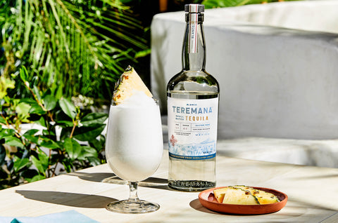 Teremana Colada cocktail next to Teremana Blanco