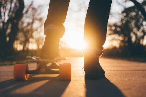 a boy skating in sunset
