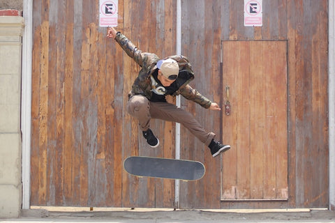 a boy skating near a wooden door