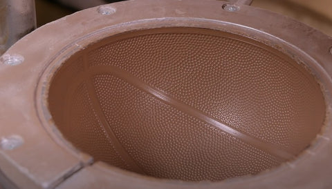 A mold that transfers the leather pattern on the basketball.