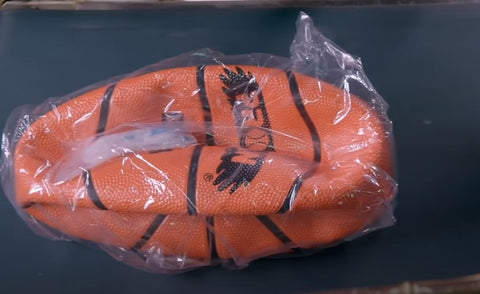 A packaged basketball ready to be sent to a retailer.