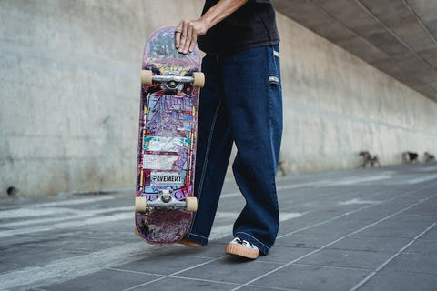 purple skateboard on road