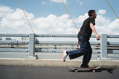 person skating over a bridge