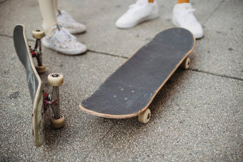 two person with two skateboards