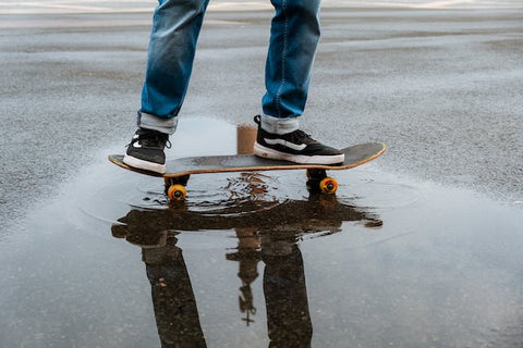 person skating on wet road