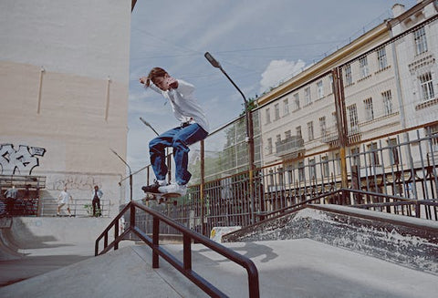 boy skating down the road