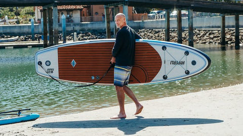 man with SUP on beach