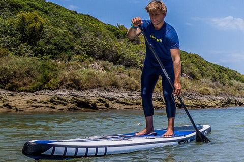 man on stand up paddle