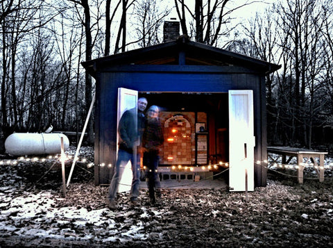 Steve and Louise in from of the BlackTree Studio Pottery kiln in winter. Happy people.