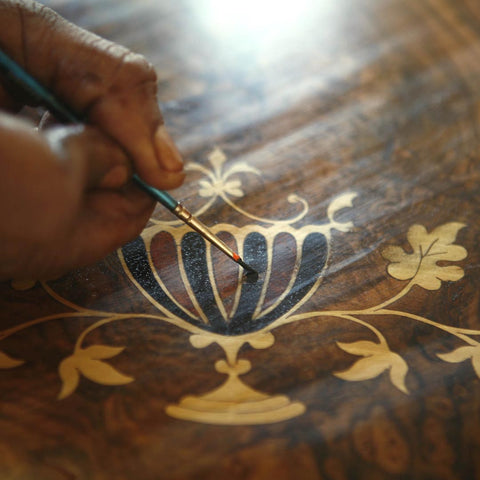 person touching up furniture decal