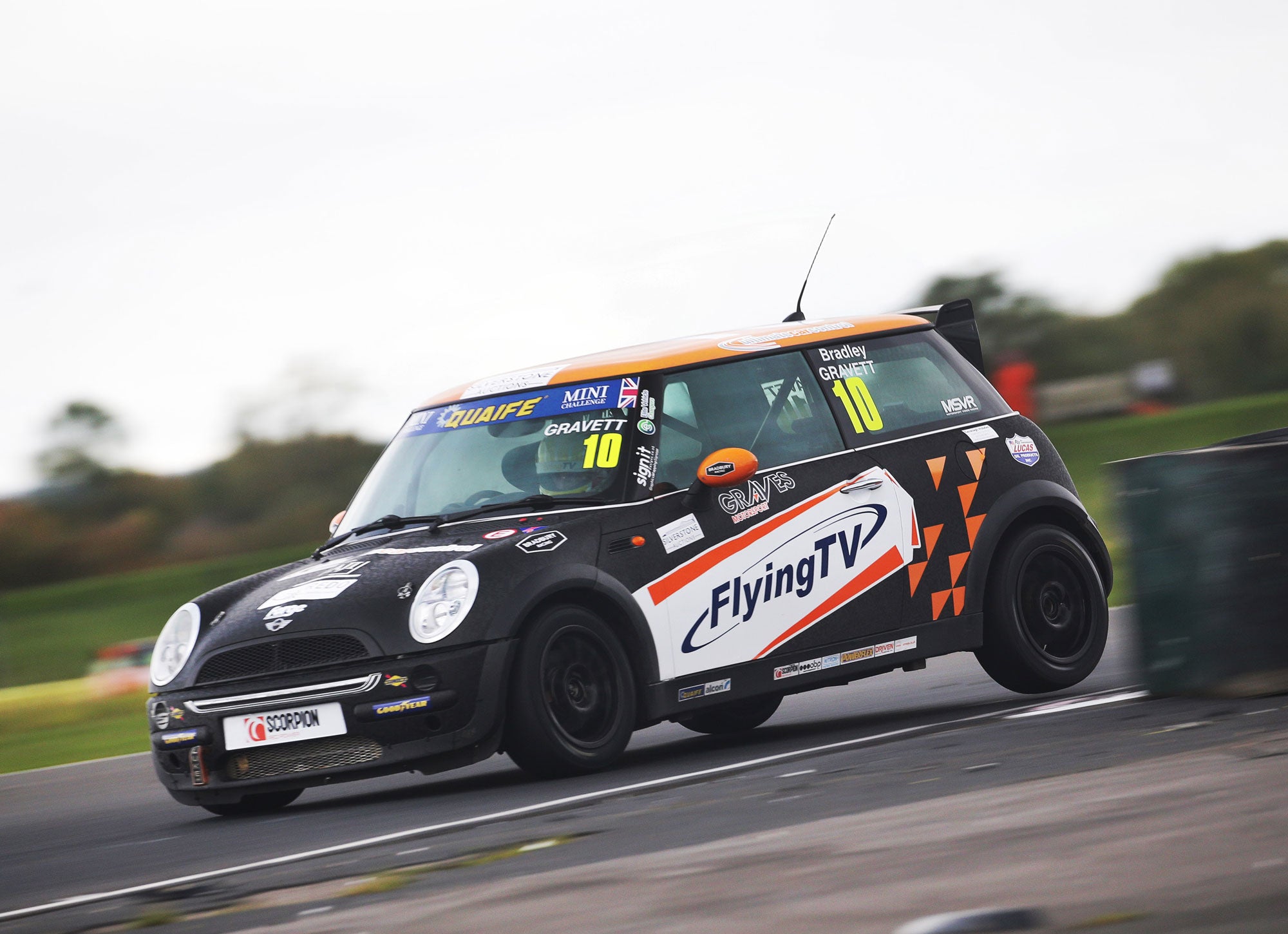 Bradley Gravett son of BTCC British Touring Car Champion Robb Gravett in the Cooper Trophy at Croft in 2020 Standing Through Exit of Chicane Graves Motorsport Mini Challenge JCW Cooper Racing Driver LIQUI MOLY LM Performance Thinking it Better