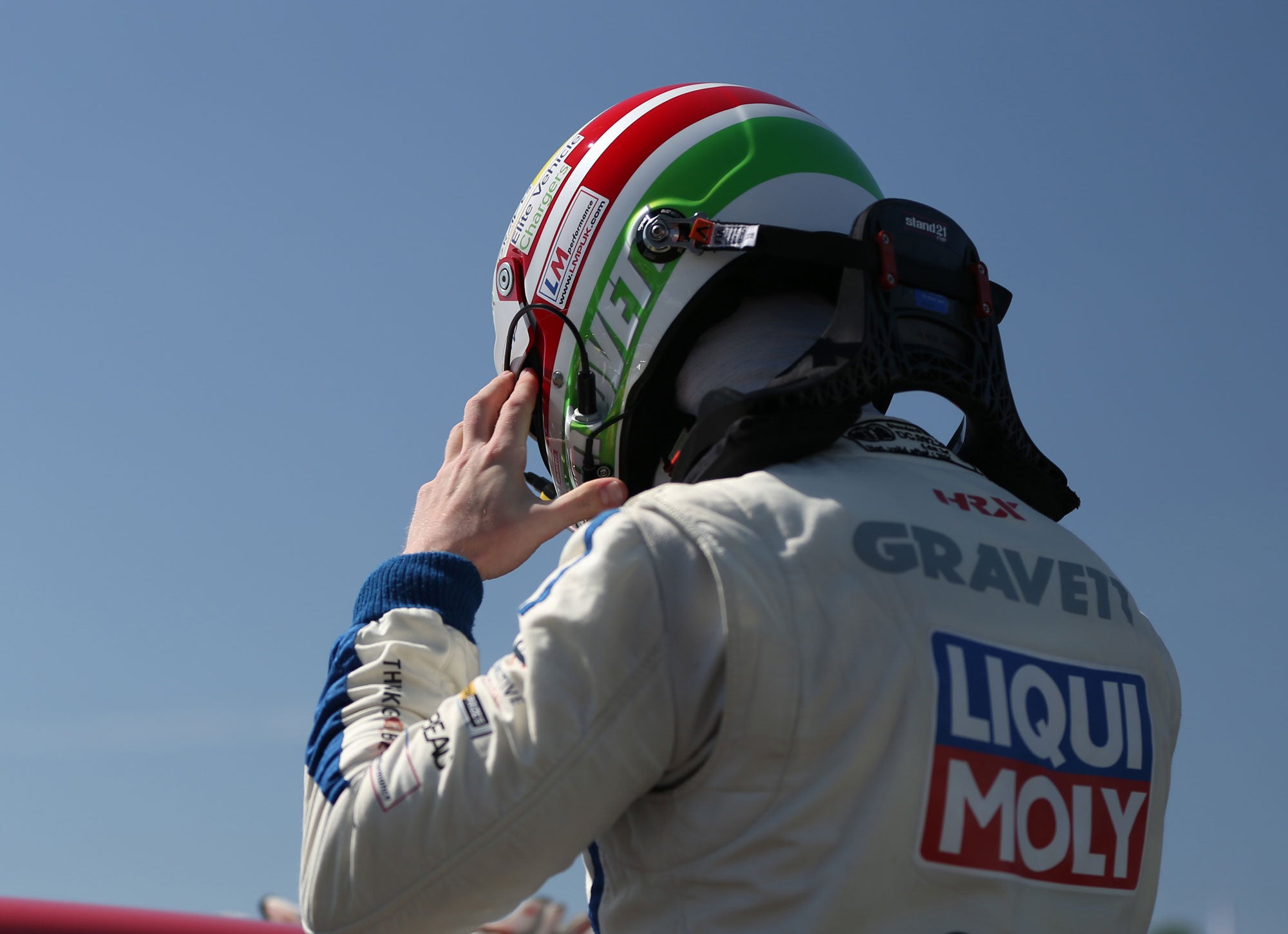 Bradley Gravett son of BTCC British Touring Car Champion Robb Gravett in the MINI Challenge JCW Series at Brands Hatch Indy in 2022 Bradley Putting on Stilo Helmet Graves Motorsport Cooper Racing Driver LIQUI MOLY LM Performance Thinking it Better