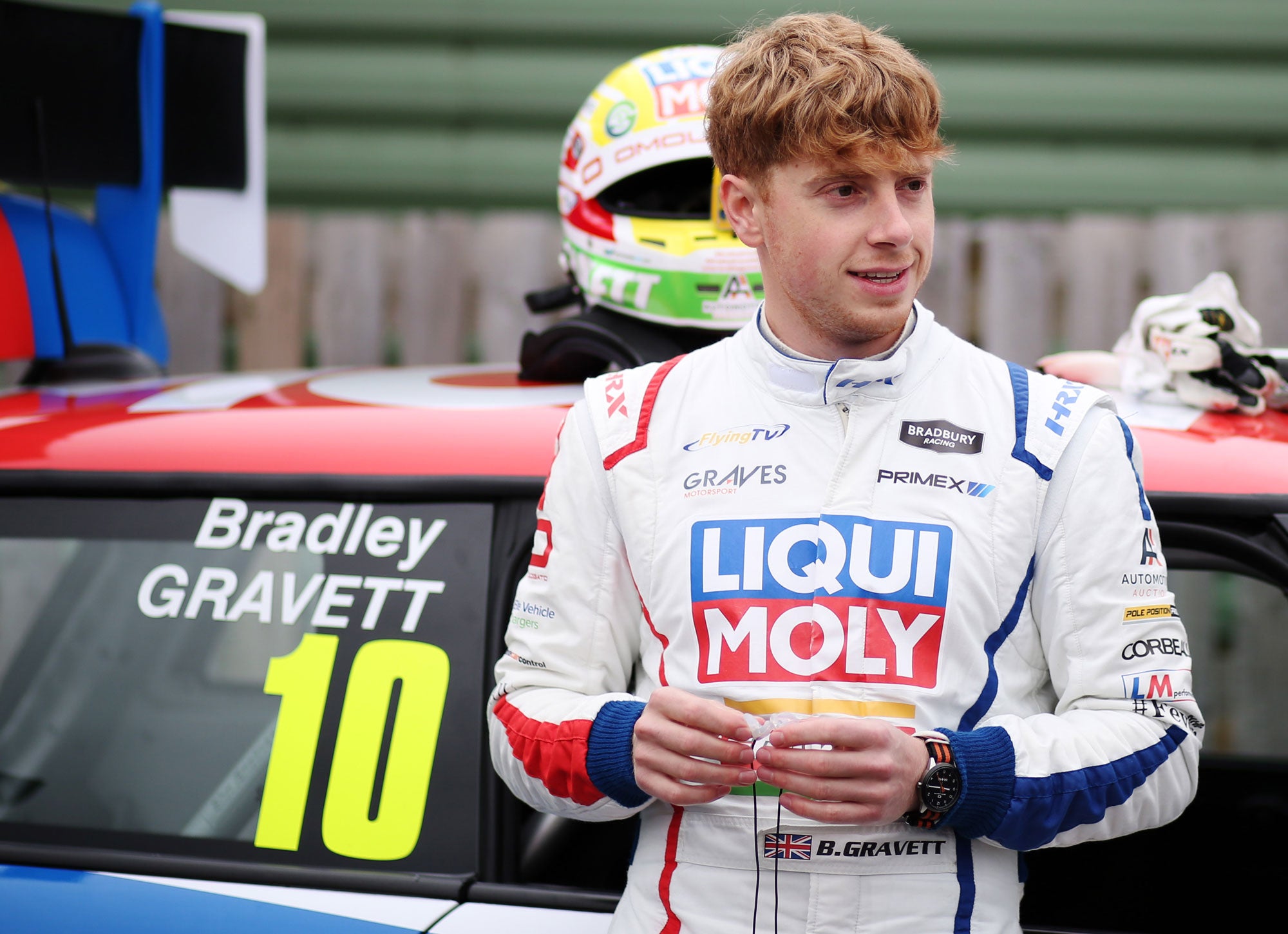 Bradley Gravett son of BTCC British Touring Car Champion Robb Gravett in the MINI Challenge JCW Series at Knockhill in 2021 Brad Standing in Front of Race Car Graves Motorsport Cooper Racing Driver LIQUI MOLY LM Performance Thinking it Better