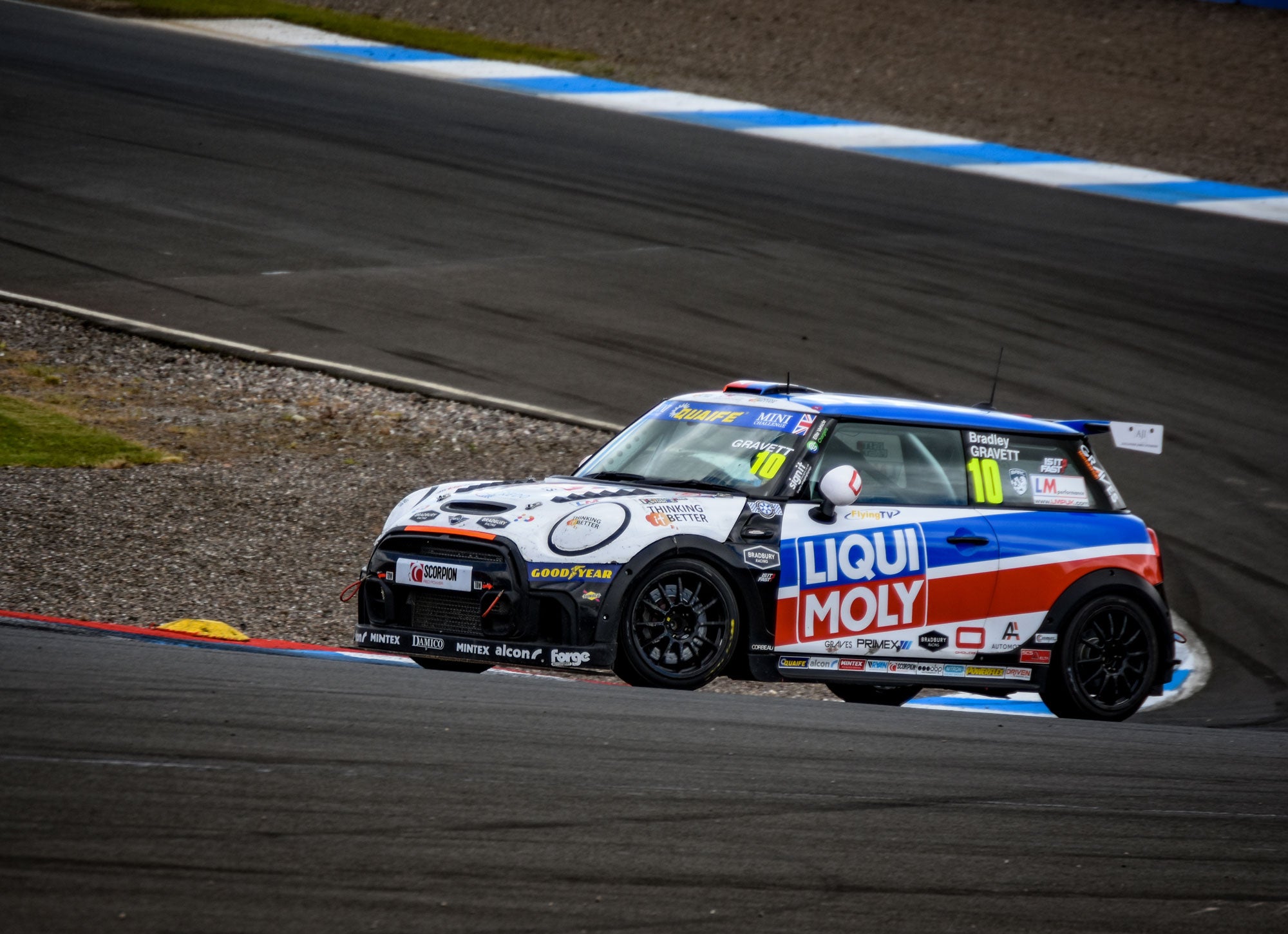 Bradley Gravett son of BTCC British Touring Car Champion Robb Gravett in the MINI Challenge JCW Series at Knockhill in 2022 Exiting Taylors Final Corner Hairpin Graves Motorsport Cooper Racing Driver LIQUI MOLY LM Performance Thinking it Better