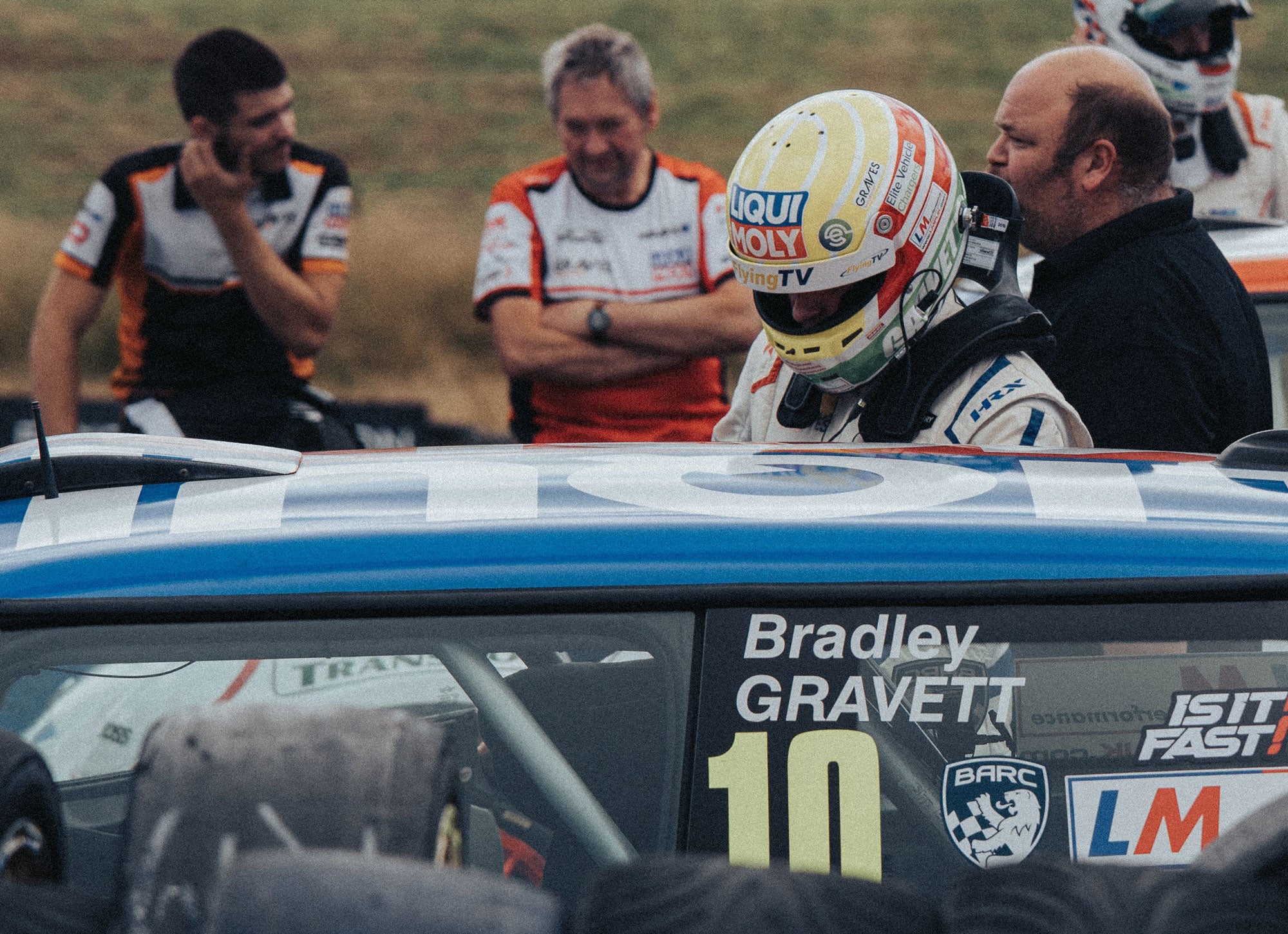 Bradley Gravett son of BTCC British Touring Car Champion Robb Gravett in the MINI Challenge JCW Series at Knockhill in 2022 in Assembly Area Getting in Car Graves Motorsport Cooper Racing Driver LIQUI MOLY LM Performance Thinking it Better