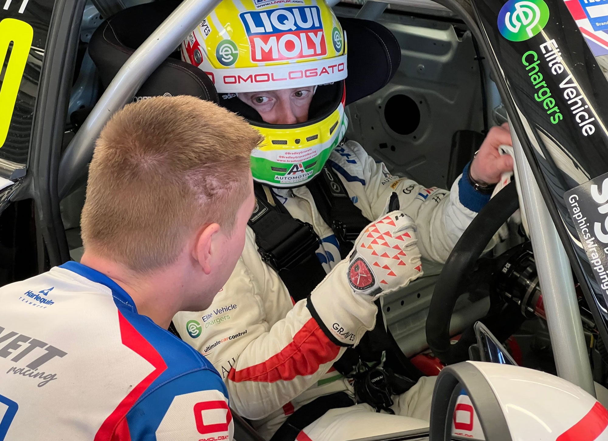 Bradley Gravett son of BTCC British Touring Car Champion Robb Gravett in the MINI Challenge JCW Series at Silverstone in 2022 Talking to Lewis Perry sat in Race Car Graves Motorsport Cooper Racing Driver LIQUI MOLY LM Performance Thinking it Better