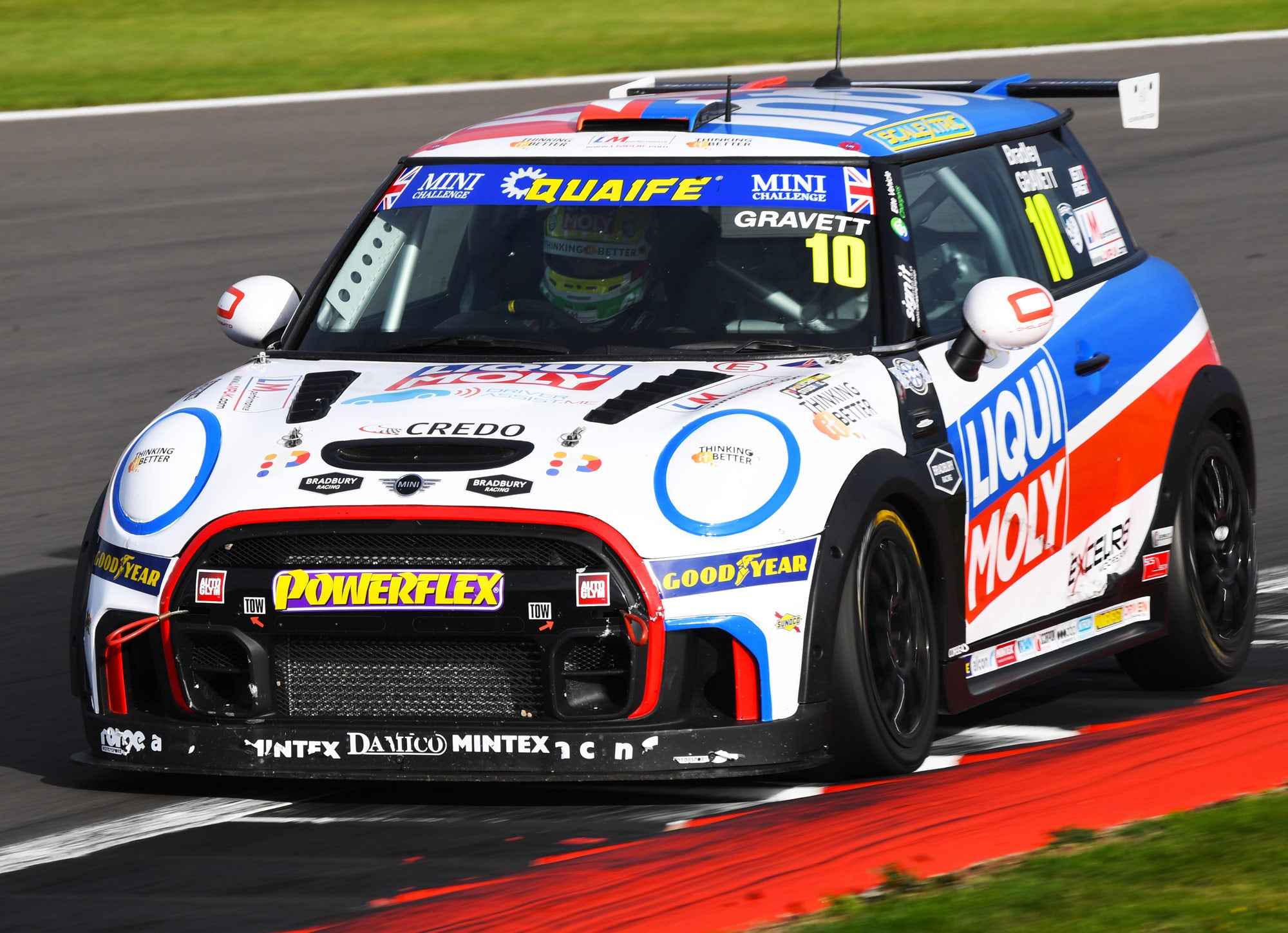 Bradley Gravett son of BTCC British Touring Car Champion Robb Gravett in the MINI Challenge JCW Series at Silverstone on the curb braking for Maggots Driver LIQUI MOLY LM Performance Thinking it Better Scalextric Elite Vehicle Chargers