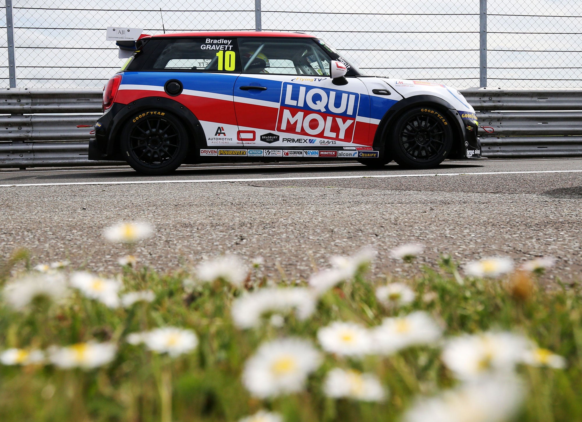 Bradley Gravett son of BTCC British Touring Car Champion Robb Gravett in the MINI Challenge JCW Series at Snetterton in 2021 with Flowers in Foreground Graves Motorsport Cooper Racing Driver LIQUI MOLY LM Performance Thinking it Better