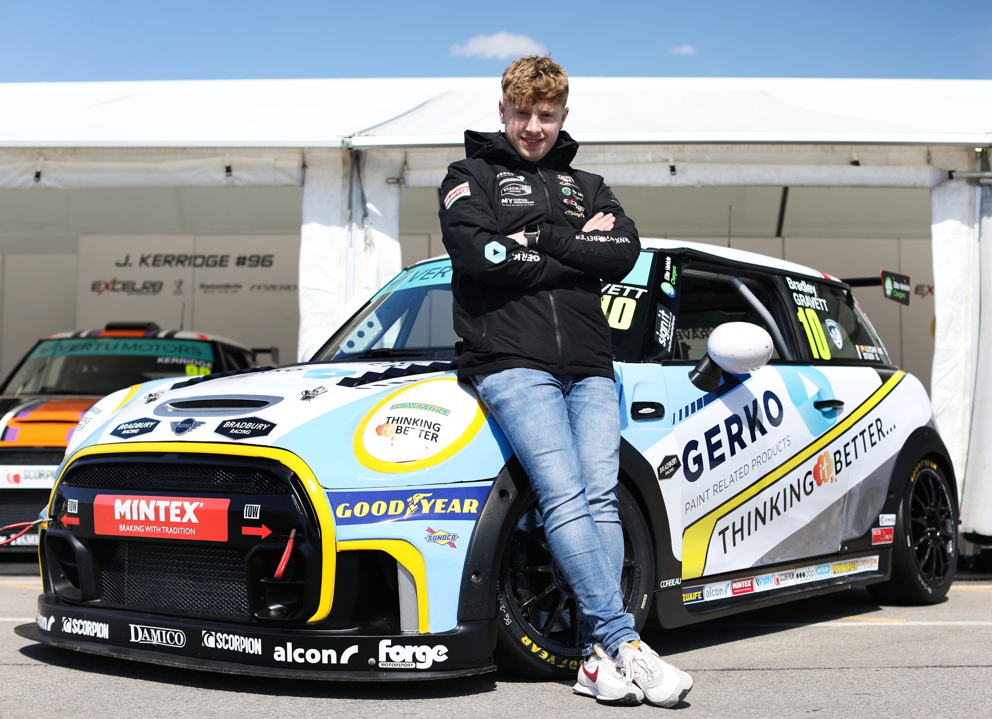 Bradley Gravett standing in front of his 2023 MINI Challenge JCW race car