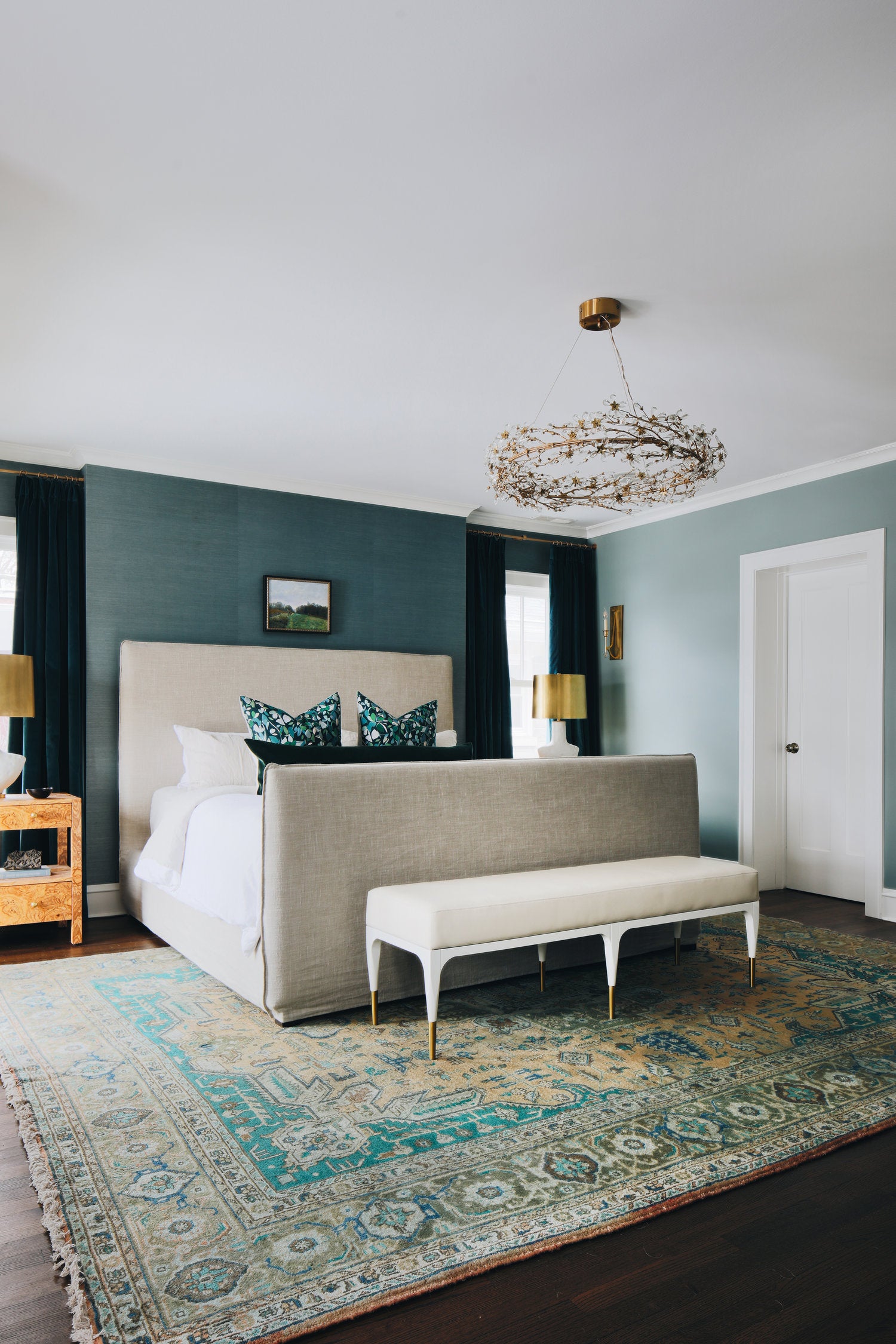 living room with grasscloth wallpaper and antique rug