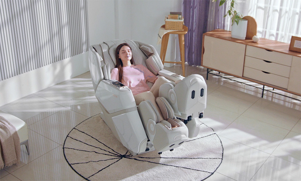 A photo of a woman comfortably seated and enjoying a massage in the Falcon massage chair.