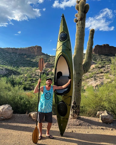 Dan Arbuckle holding a Sandpiper 130 upright next to a large cactus.