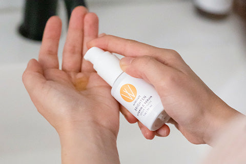 A Hand Holding Brighten Vitamin C Face Serum