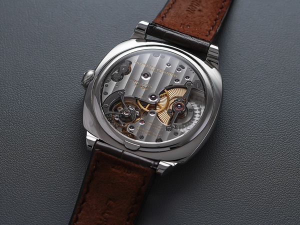 Montre-bracelet cuir marron, vue sur le mécanisme arrière, avec le micro rotor encastré dans le mouvement 