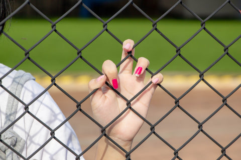 hand holding a wire fence