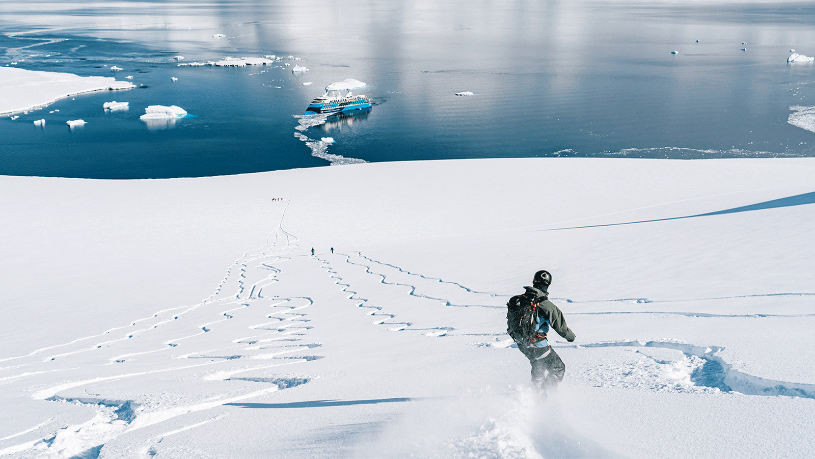 snowboarder among rows of ski squiggle lines