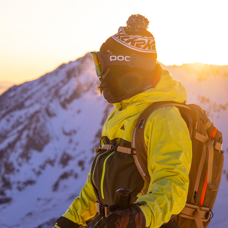 skier at sunset in lime pyramid jacket