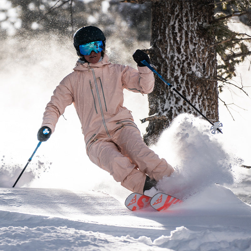 aspen mountain powder turn with skier in peachy sickbed suit