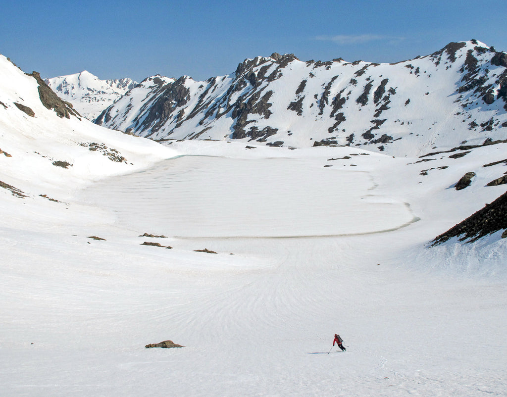 Skier headed towards frozen lake