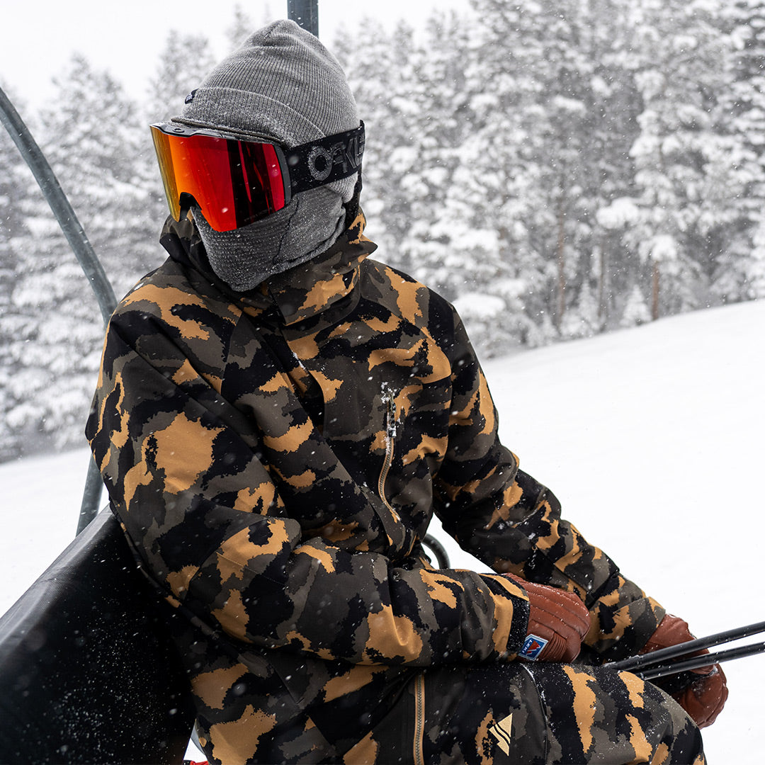 riding a chairlift in the dune camo hayden jacket