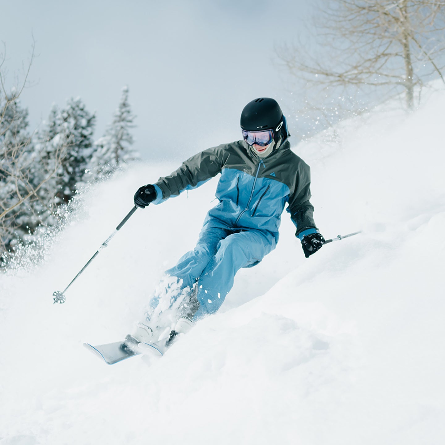 sam blakeslee skier making a powder turn in pyramid jacket