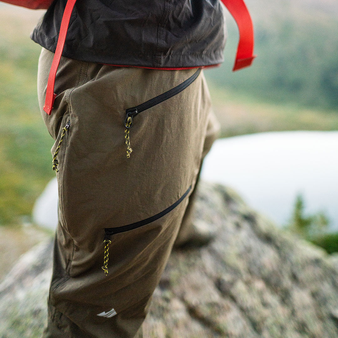 close-up of olive recon pant leg on fall hike