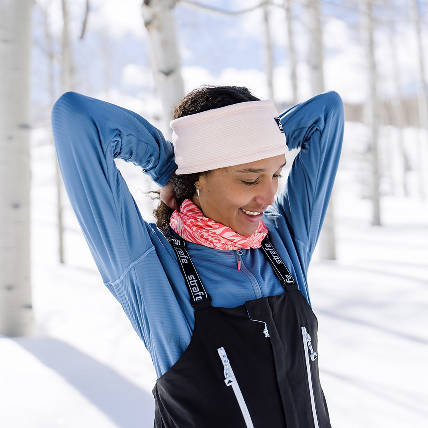 tying hair in womens basecamp hoodie