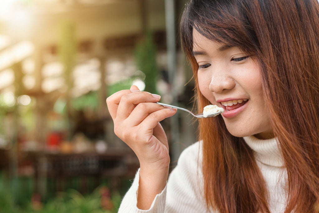 woman eats yogurt probiotics