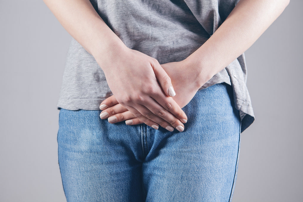 woman rests hands over intestine gut