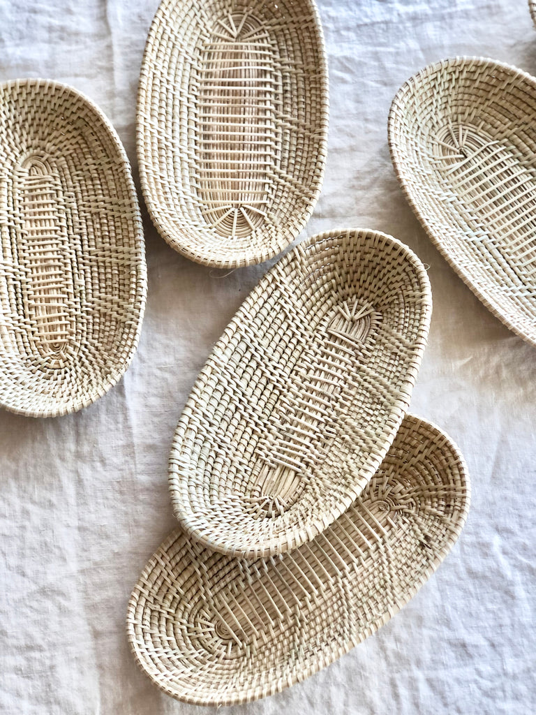 little woven oval baskets assorted layout on a white table cloth