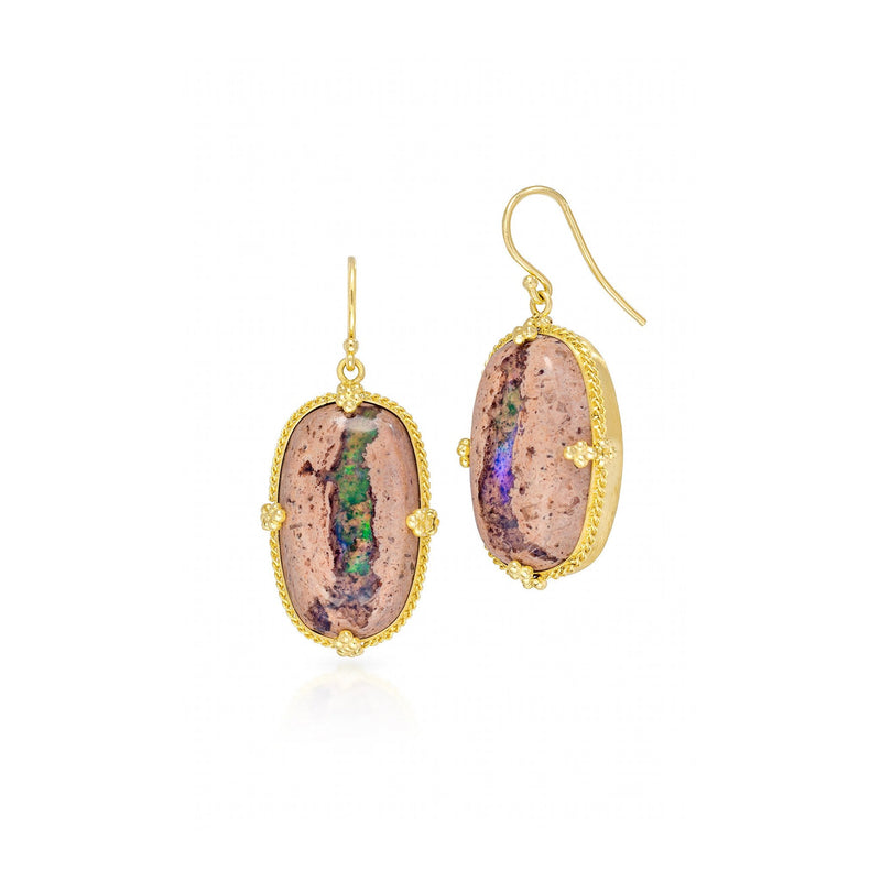 This pair of Mexican opal earrings are set in 18k yellow gold chain wrapped bezels with four beaded prongs. The earrings fasten with French hook closures.