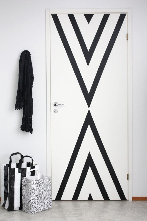 7b Unexpected Things to Stripe with Easy Stripe by @wallsneedlove | Use vinyl striping to add interest to a door! Super cool DIY