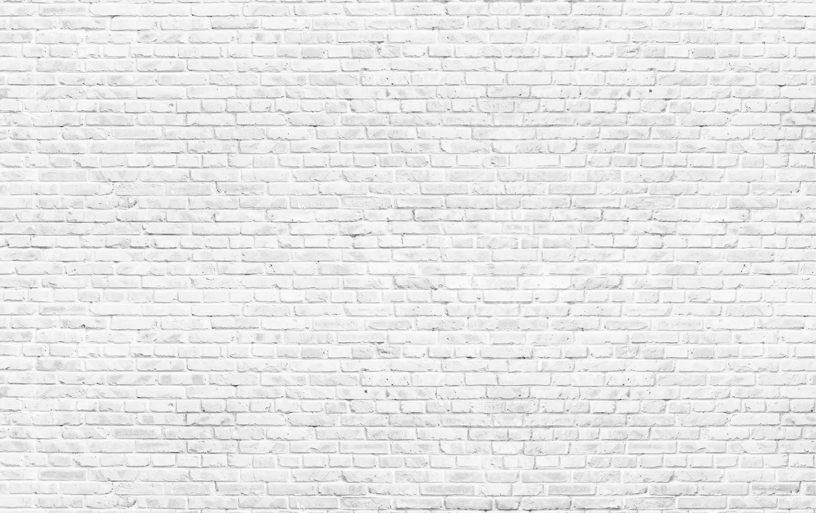 white brick wall with white kitchen