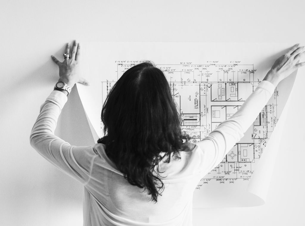 Image of woman putting up floor plan for best floor plan software