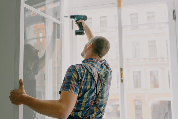 a man installing a window