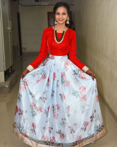 Sejal wearing a white striped floral pleated skirt designed from our Organza Fabric Collection. 4 meters of fabric was used in making this garment.