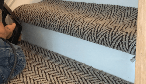 finishing off the bottom carpeting of the stair treads